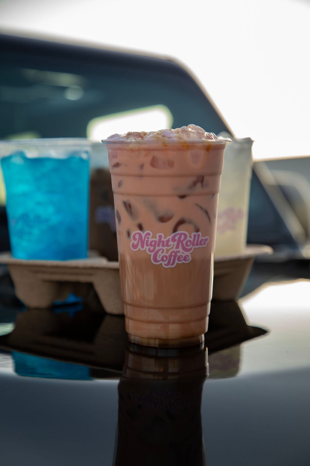 Iced chai held in a car window