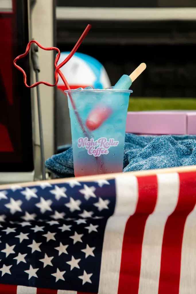 Night Roller tailgate setup with drinks and flags
