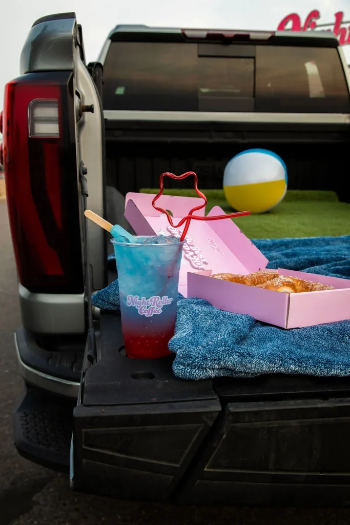 Night Roller tailgate setup with drinks and flags