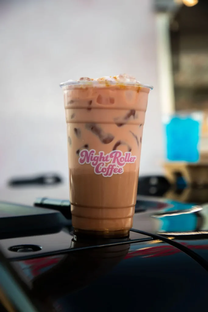 Iced coffee in a Night Roller Coffee cup
